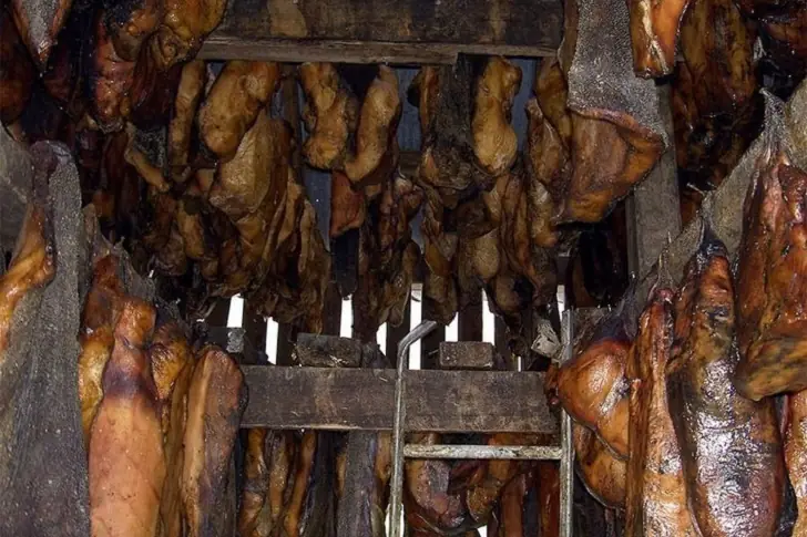 Weirdest foods - Fermented shark meat hanging in an old smokehouse.